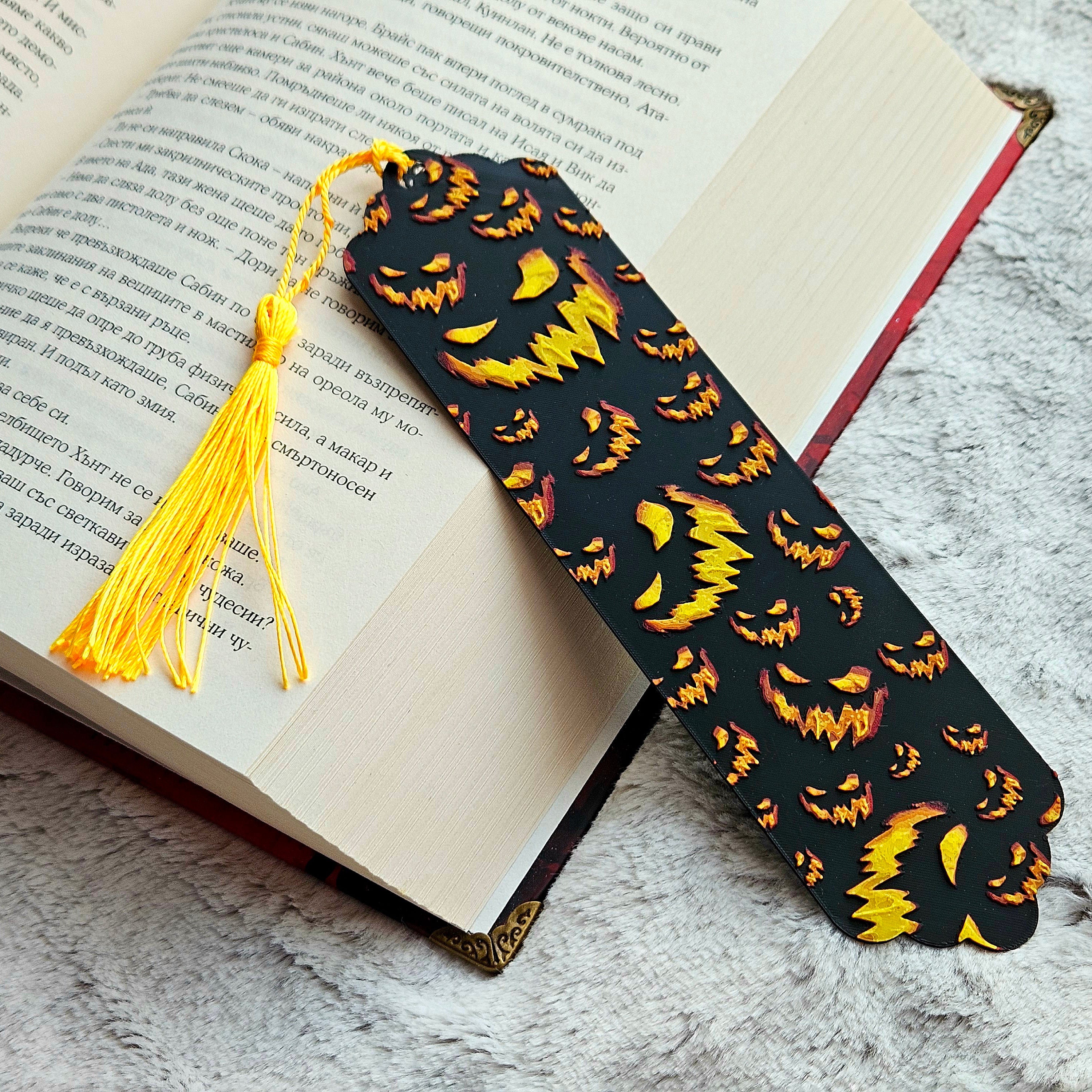 Black bookmark with pumpkin pattern on an open book