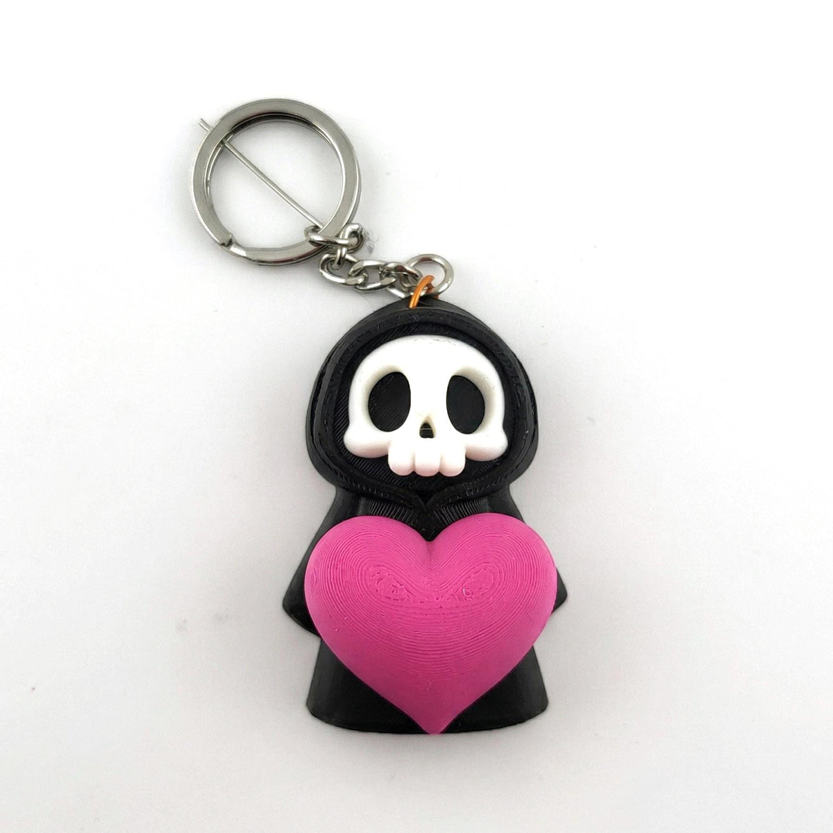 Big Heart keyring: a grim reaper holding a big pink heart