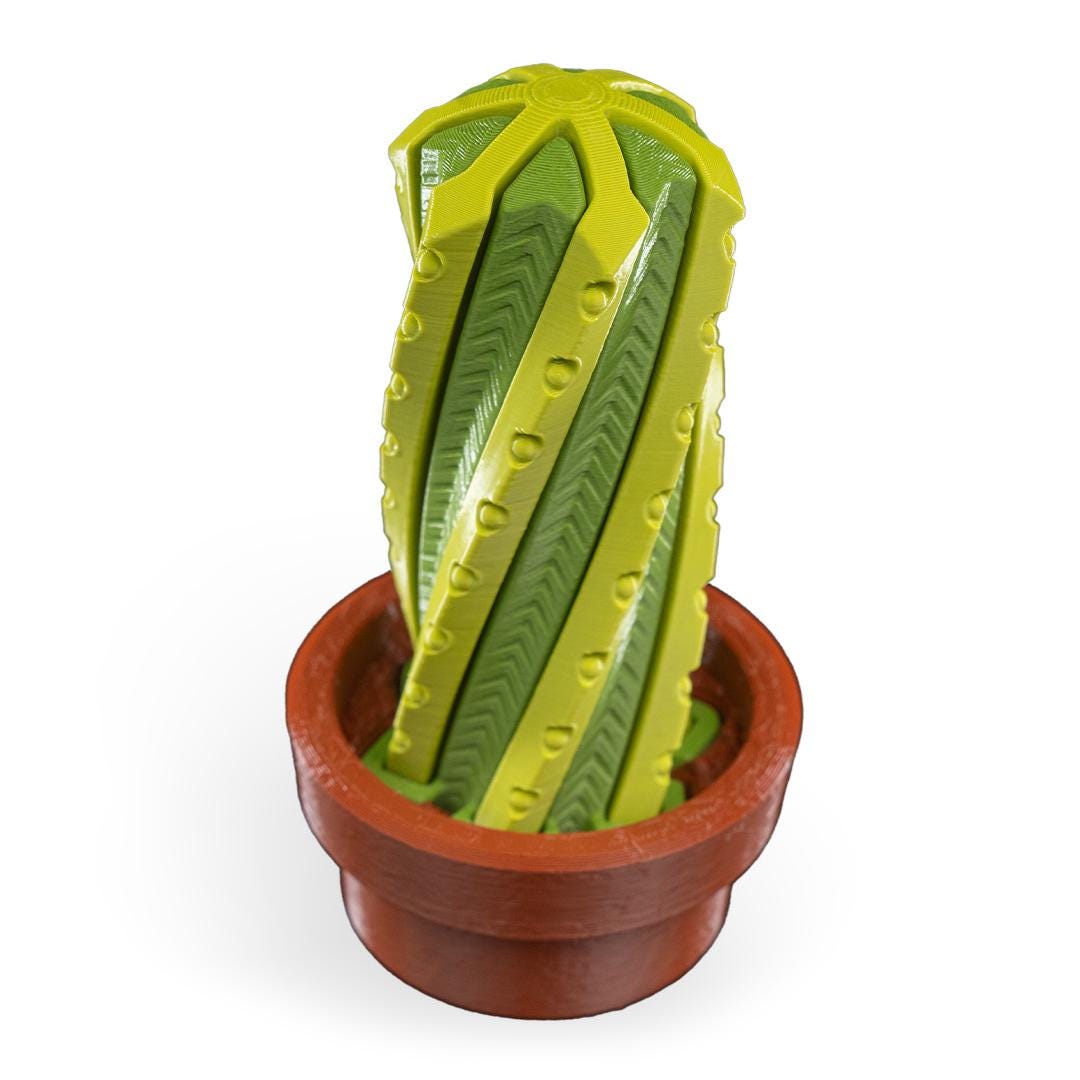 Cactus-shaped toy with a terracotta pot on a white background