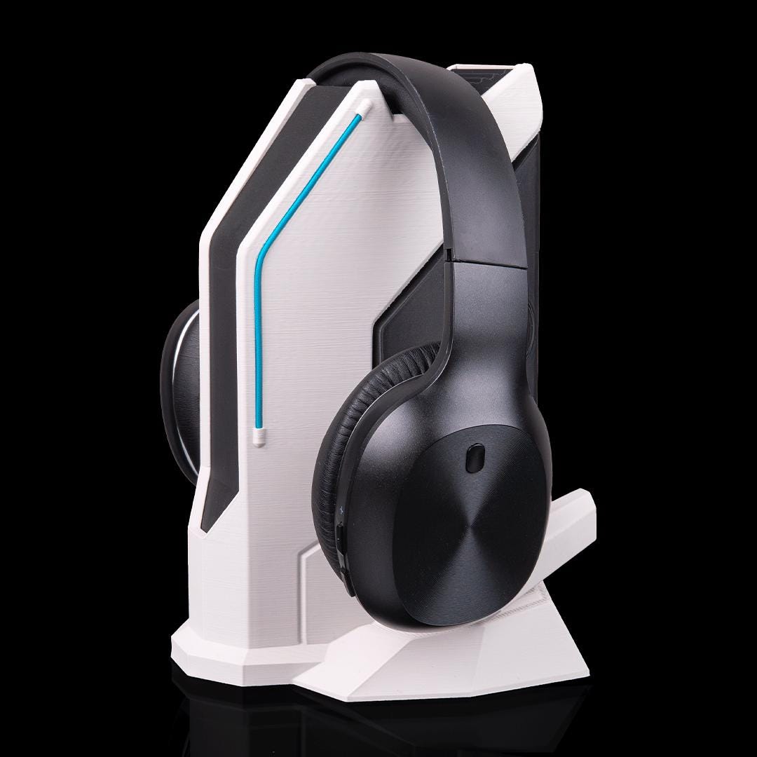 Sci-fi headset stand with black headphones, from an angle