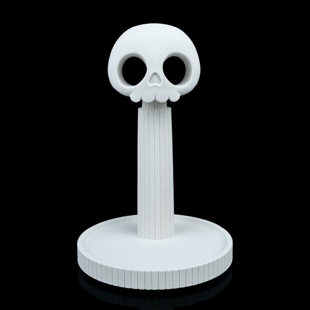 Empty white skull headphone stand from the front