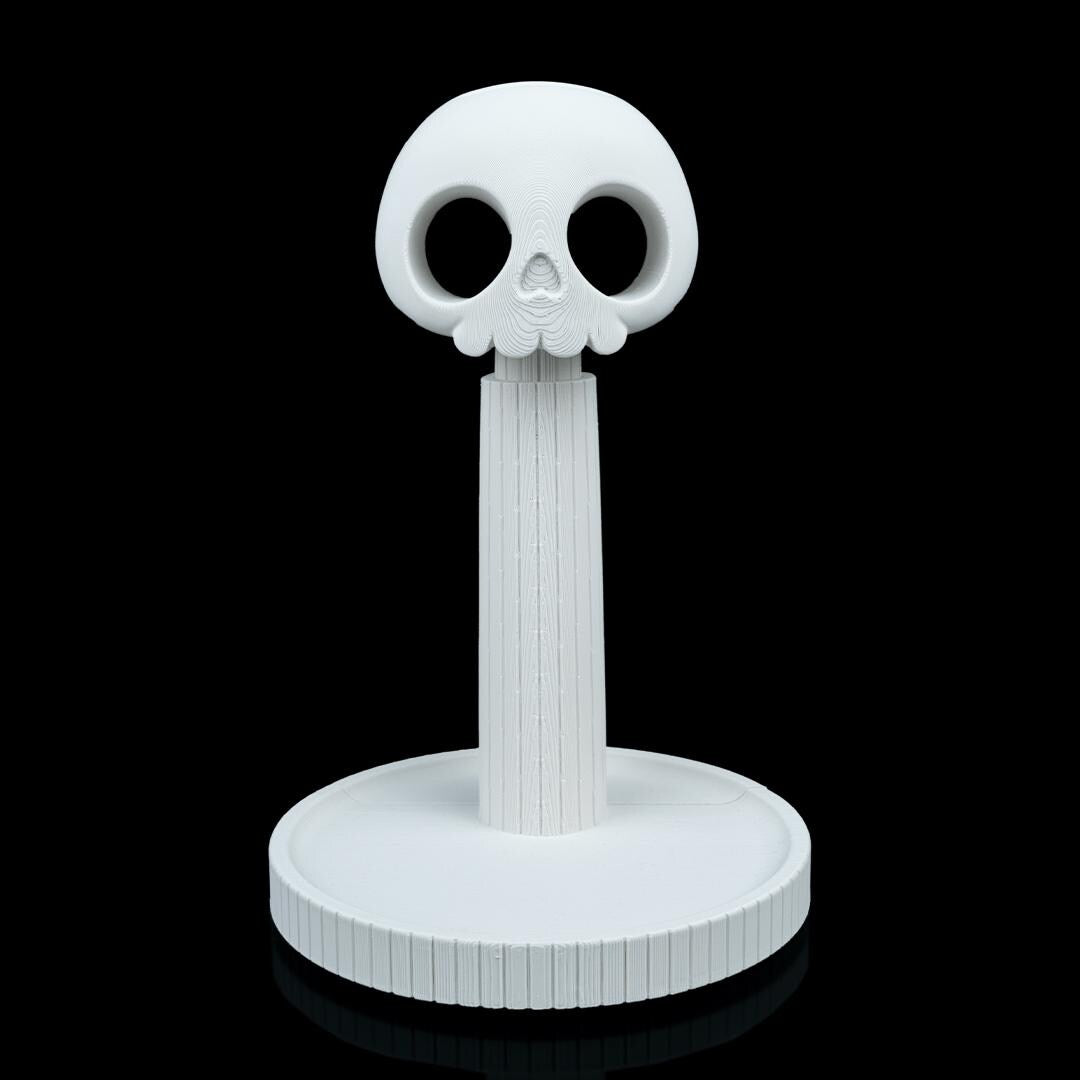 Empty white skull headphone stand from the front