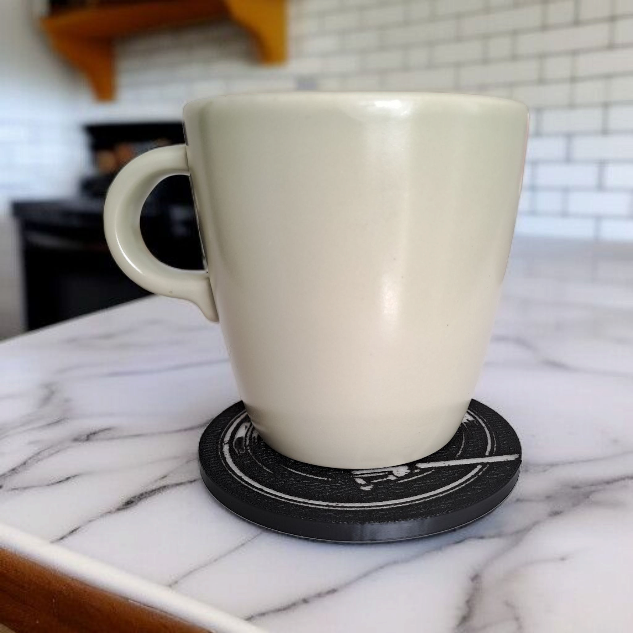 3D printed turntable-inspired drink coaster holding a white coffee mug