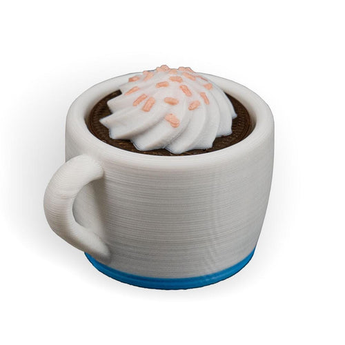 Ceramic mug with a chocolate interior and whipped cream on a white background