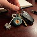 Keychain with keys and a decorative charm on a wooden surface
