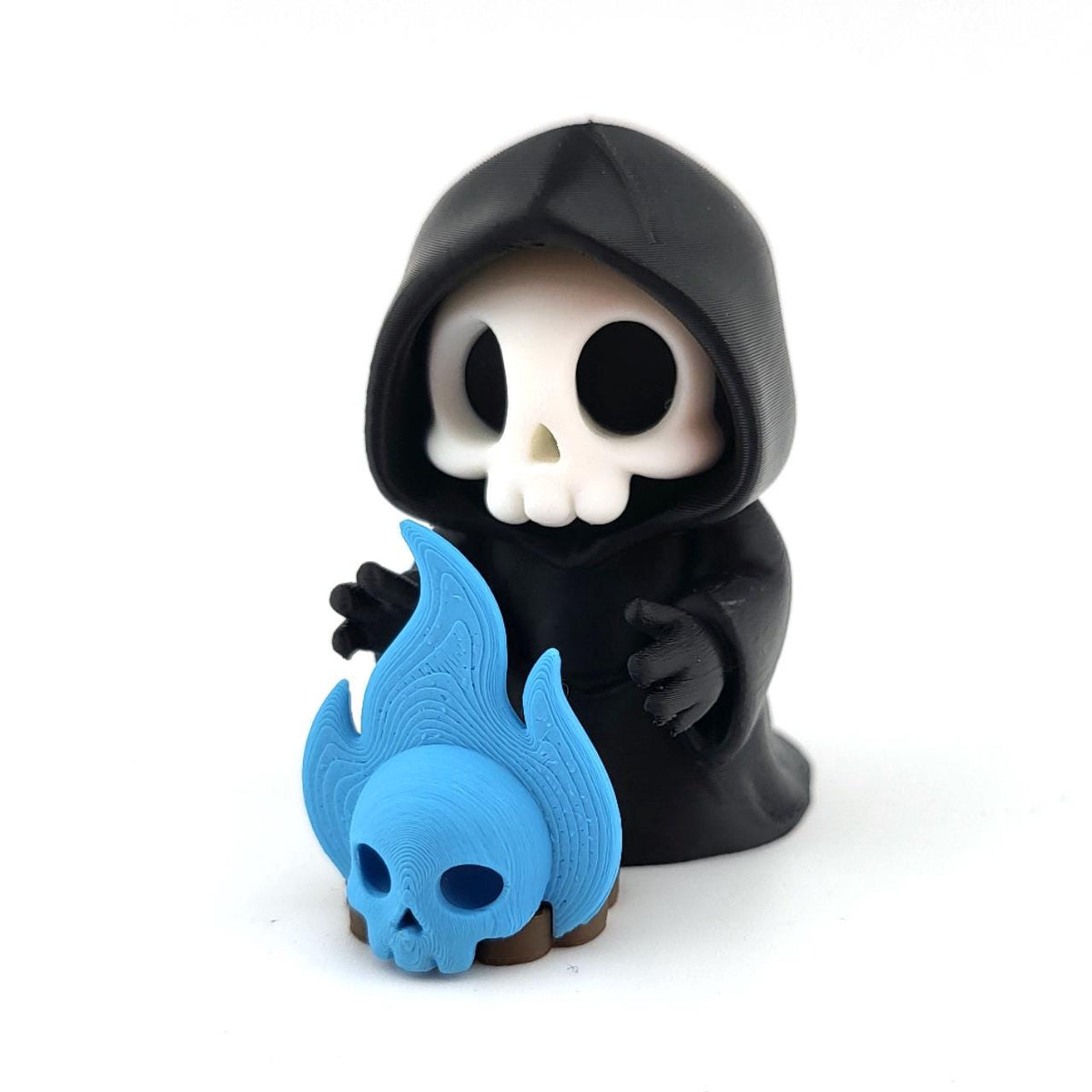 The Soul-Keeper grim reaper beside a blue soul-fire skull