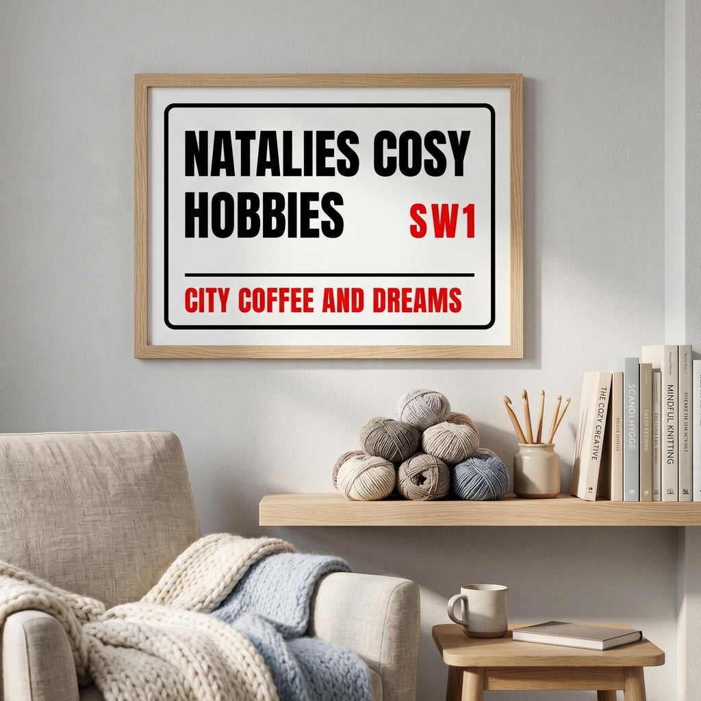 Street sign print reading Natalie's Cosy Hobbies, SW1, City Coffee and Dreams, above a reading chair