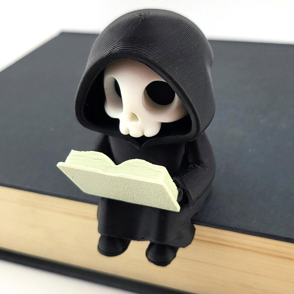 The Reader grim reaper sitting on the edge of a book, reading a pale green spell book