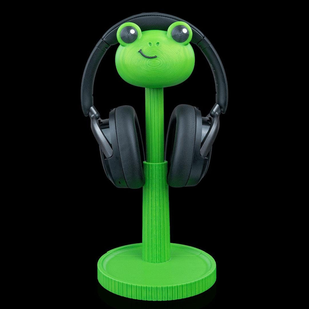 Green frog headphone stand with black headphones
