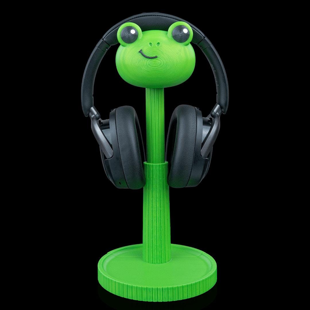 Green frog headphone stand with black headphones