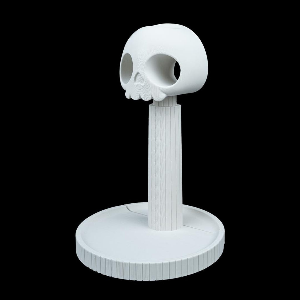 White skull headphone stand from an angle