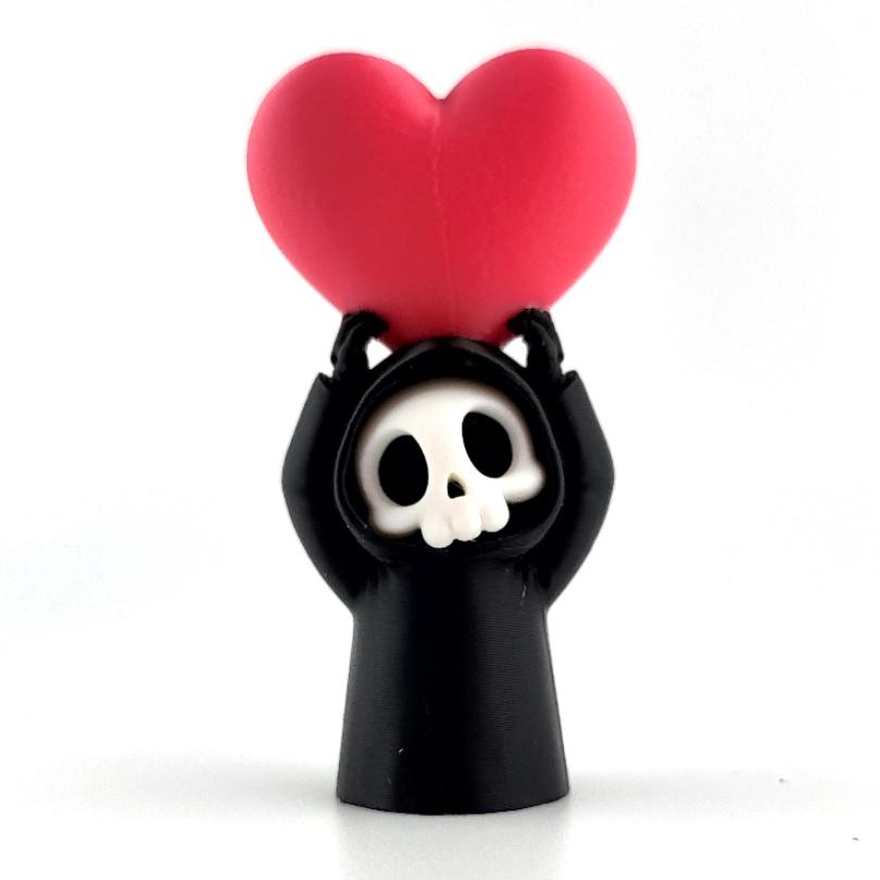 The Heart-Lifter grim reaper holding a big red heart above his head