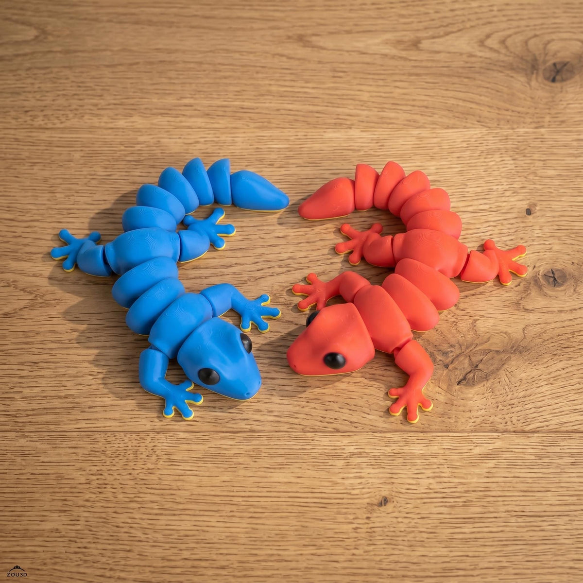 Blue and red articulated geckos side by side