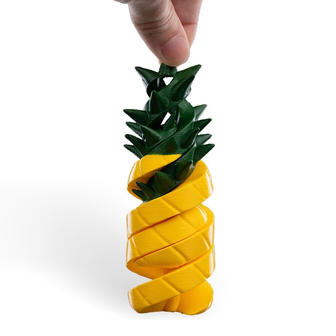Pineapple-shaped container with a hand holding it on a white background