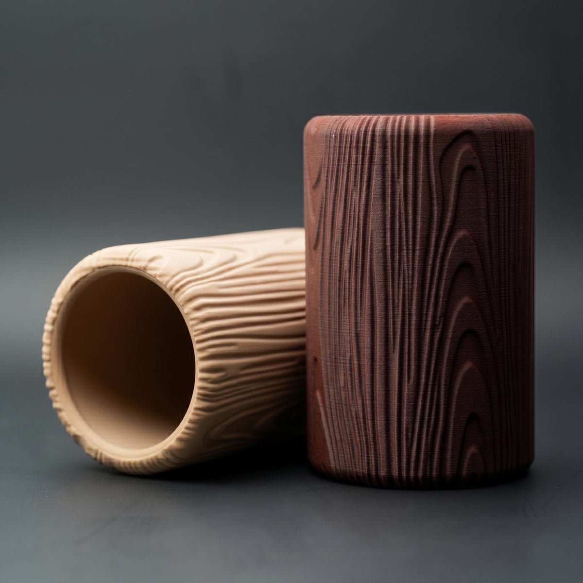 Light wood pot lying on its side beside the dark one
