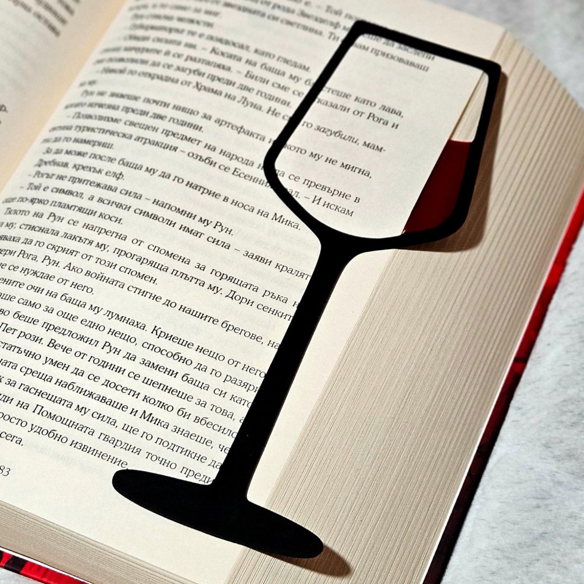 Wine glass bookmark standing in an open book