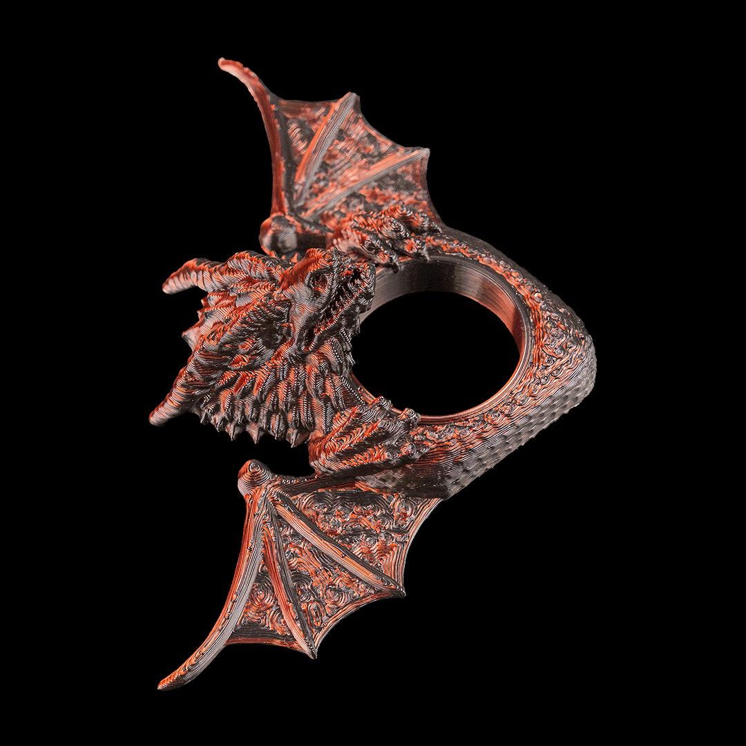 Dragon page holder from the side, showing the scales and a wing