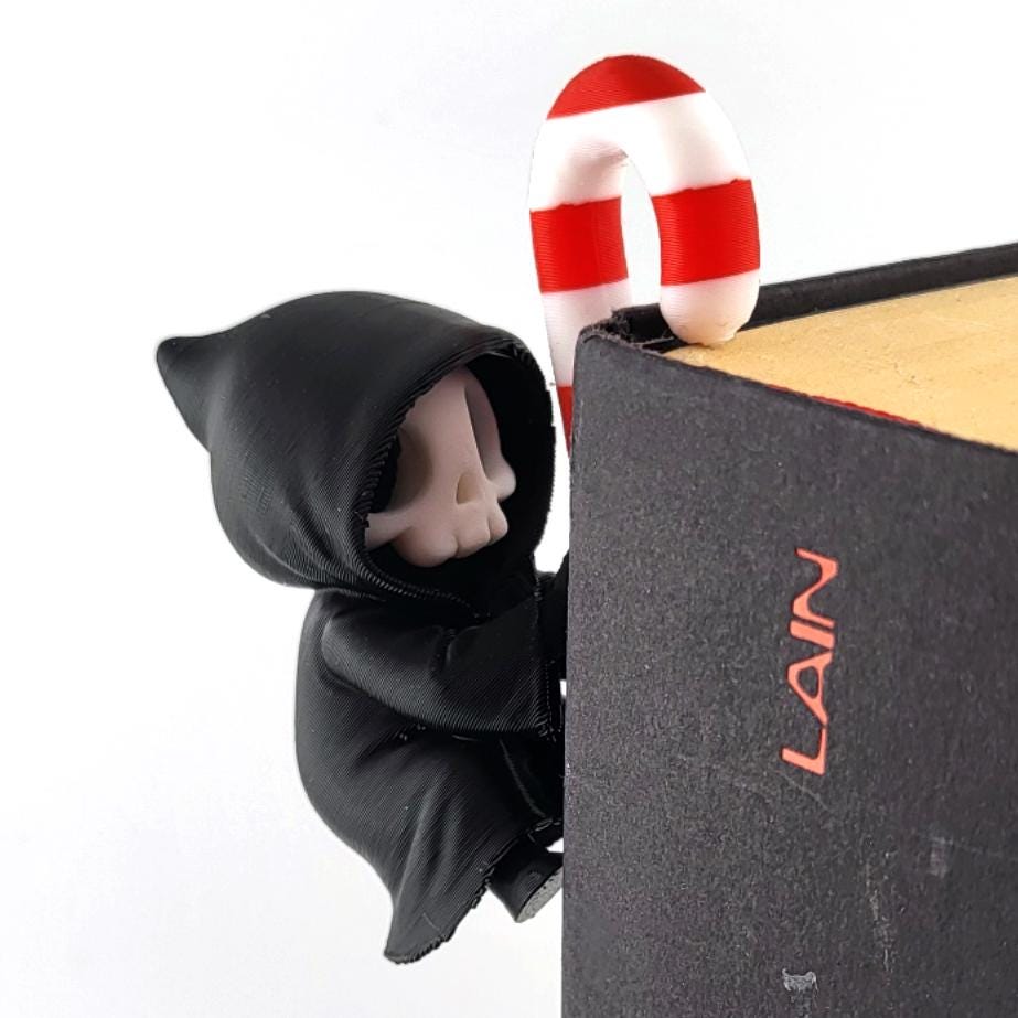 Book Climber: a grim reaper climbing over the top corner of a book with a candy cane