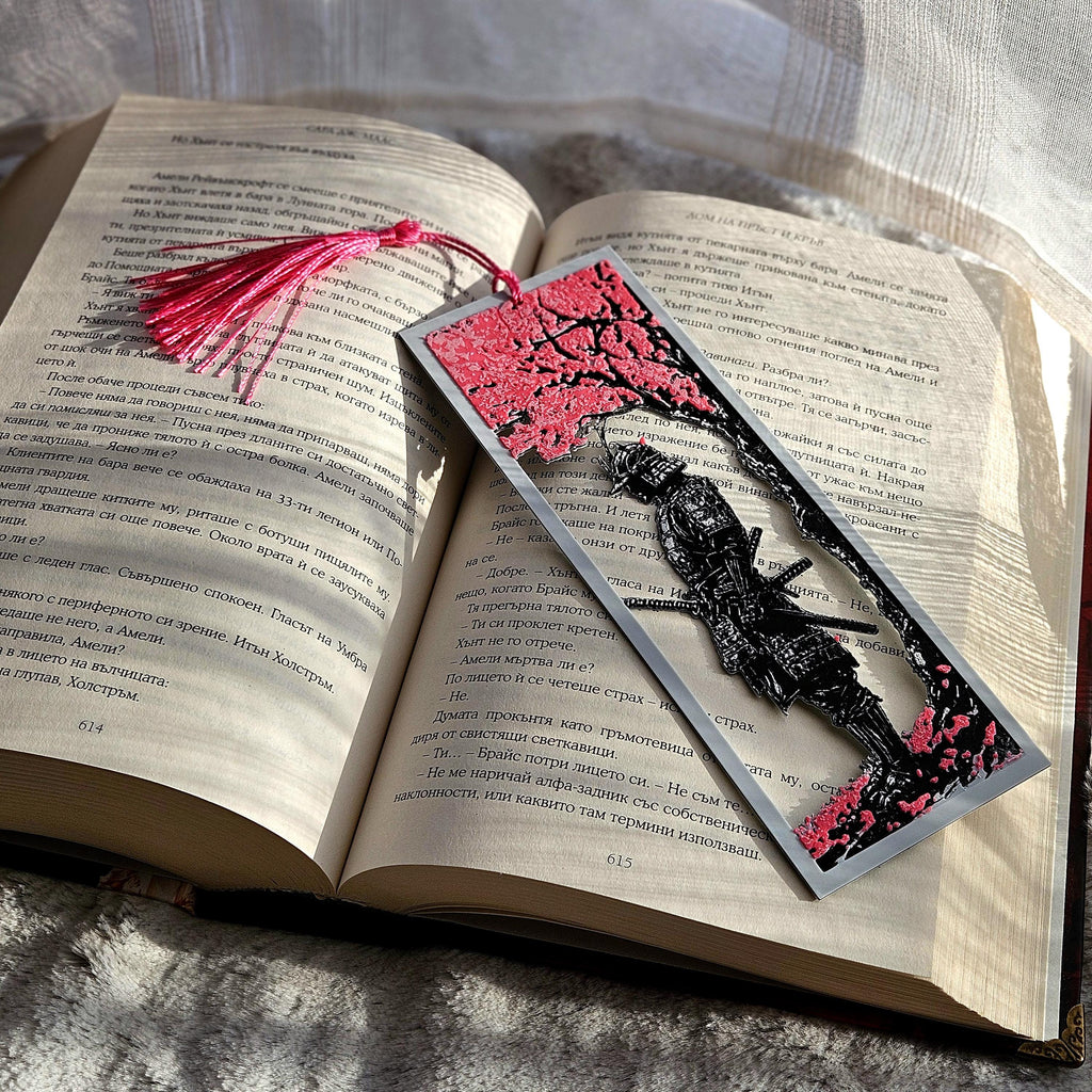 Decorative bookmark with cherry blossom design on an open book
