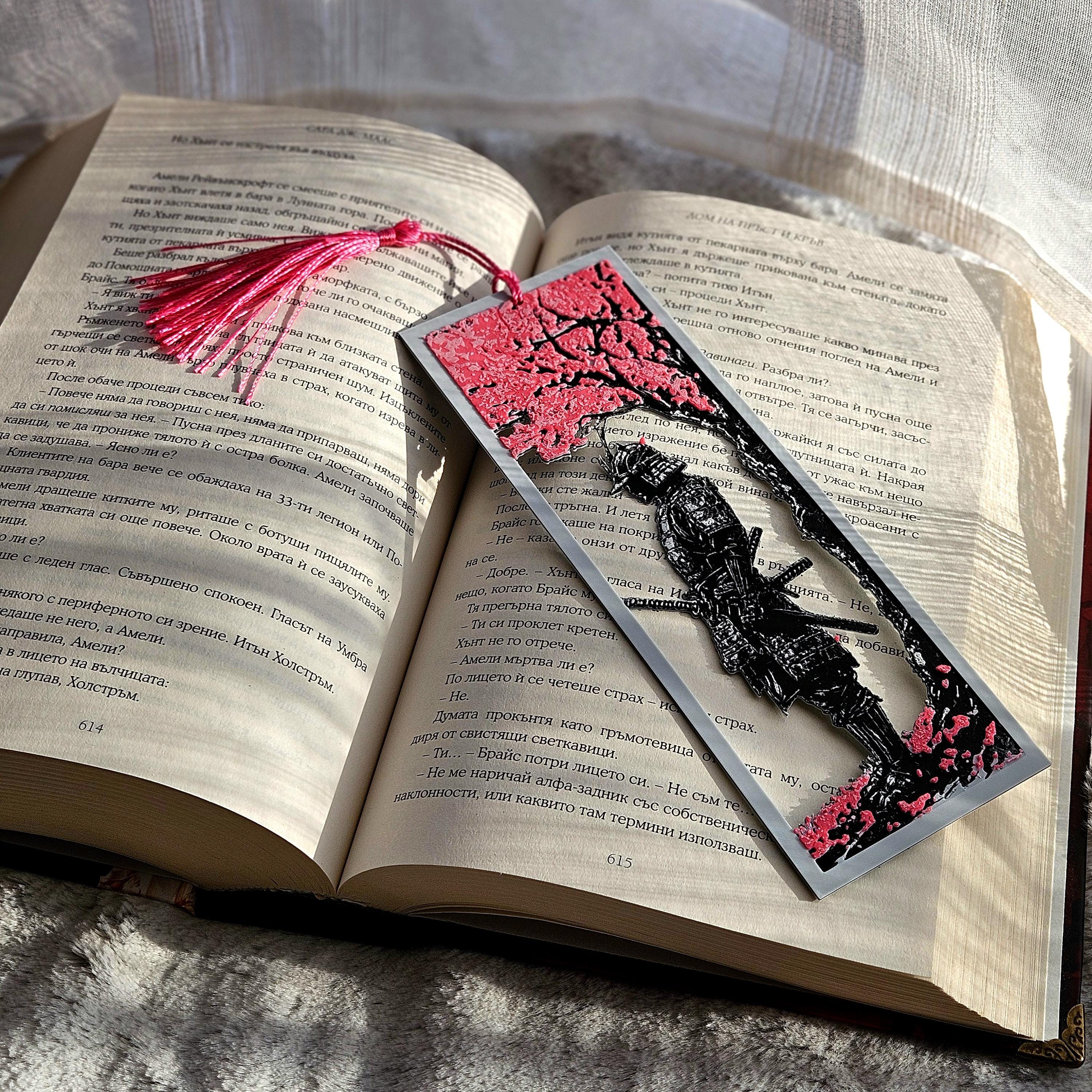 Decorative bookmark with cherry blossom design on an open book