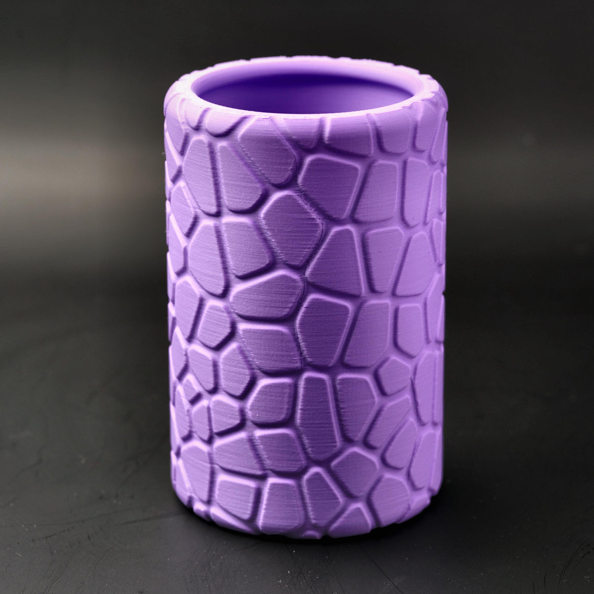 Purple geometric pencil pot with its raised cobblestone pattern