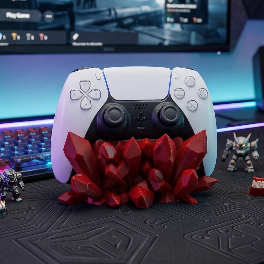 Red crystal controller stand holding a white PS5 controller on a gaming desk