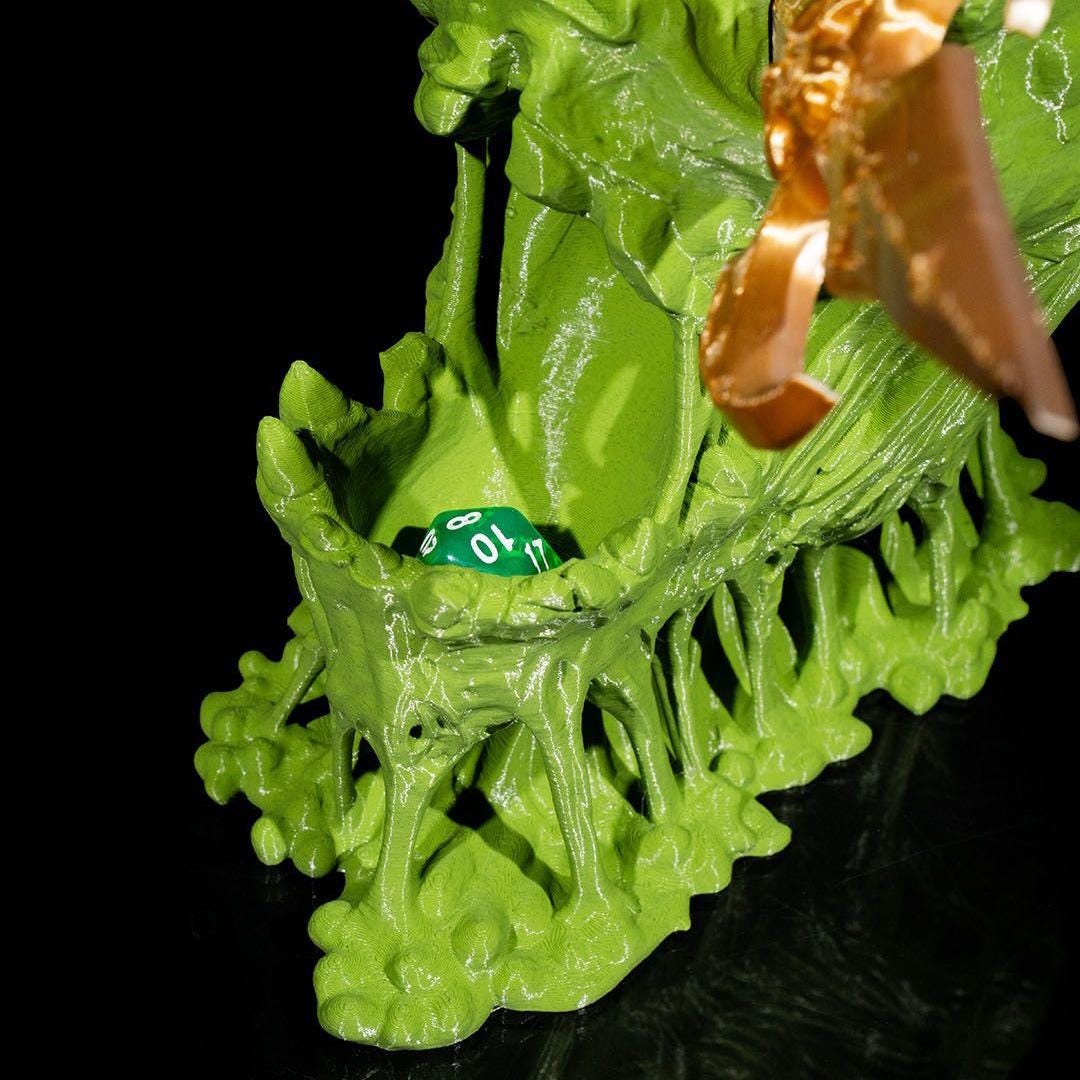 Close-up of a green plastic toy figure with a brown object on a black background
