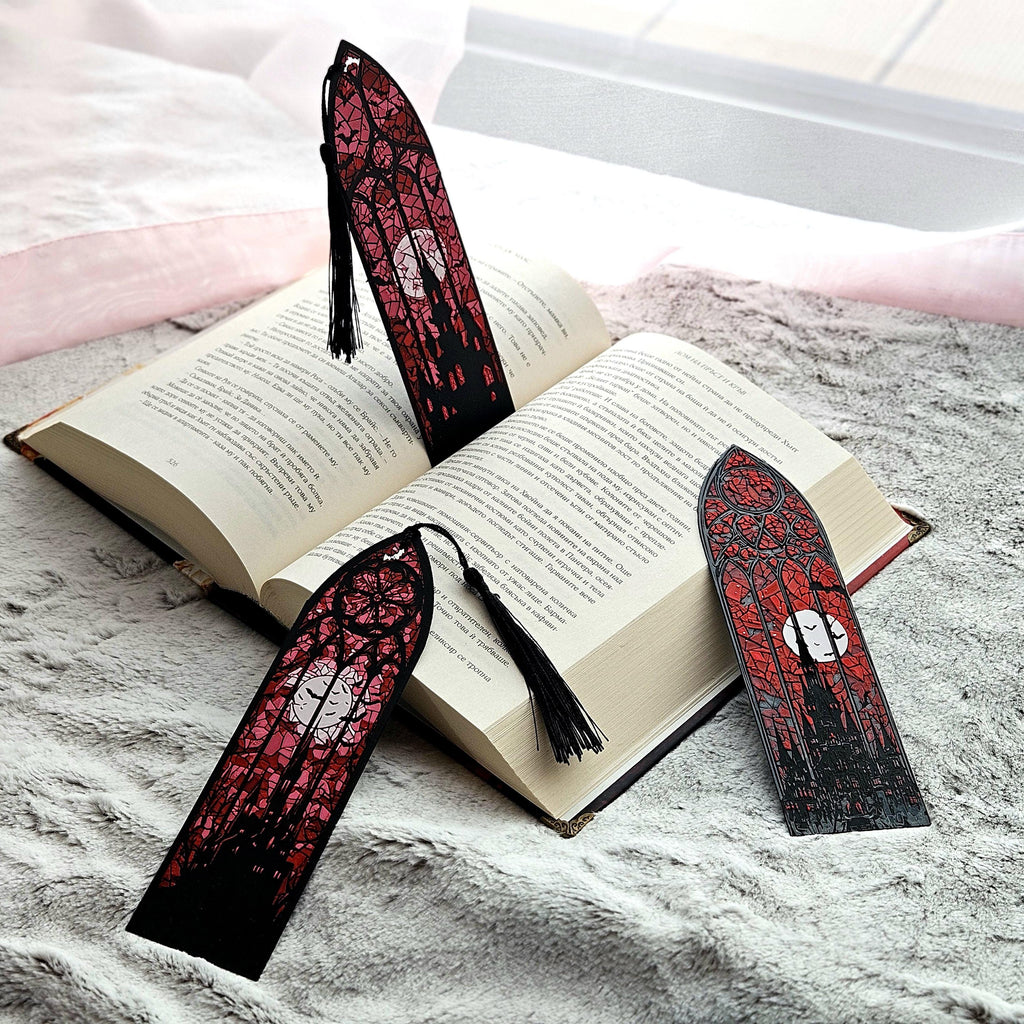 Two stained glass bookmarks on and beside an open book