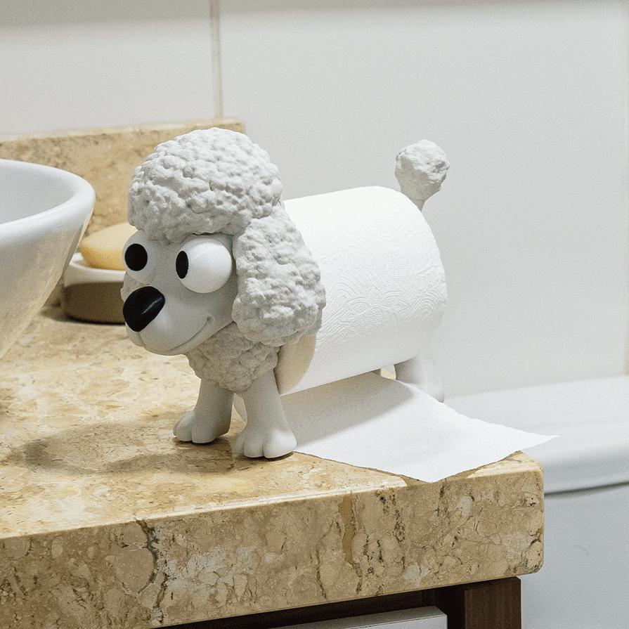 White Poopoodle toilet roll holder on a bathroom counter, a toilet roll for its body