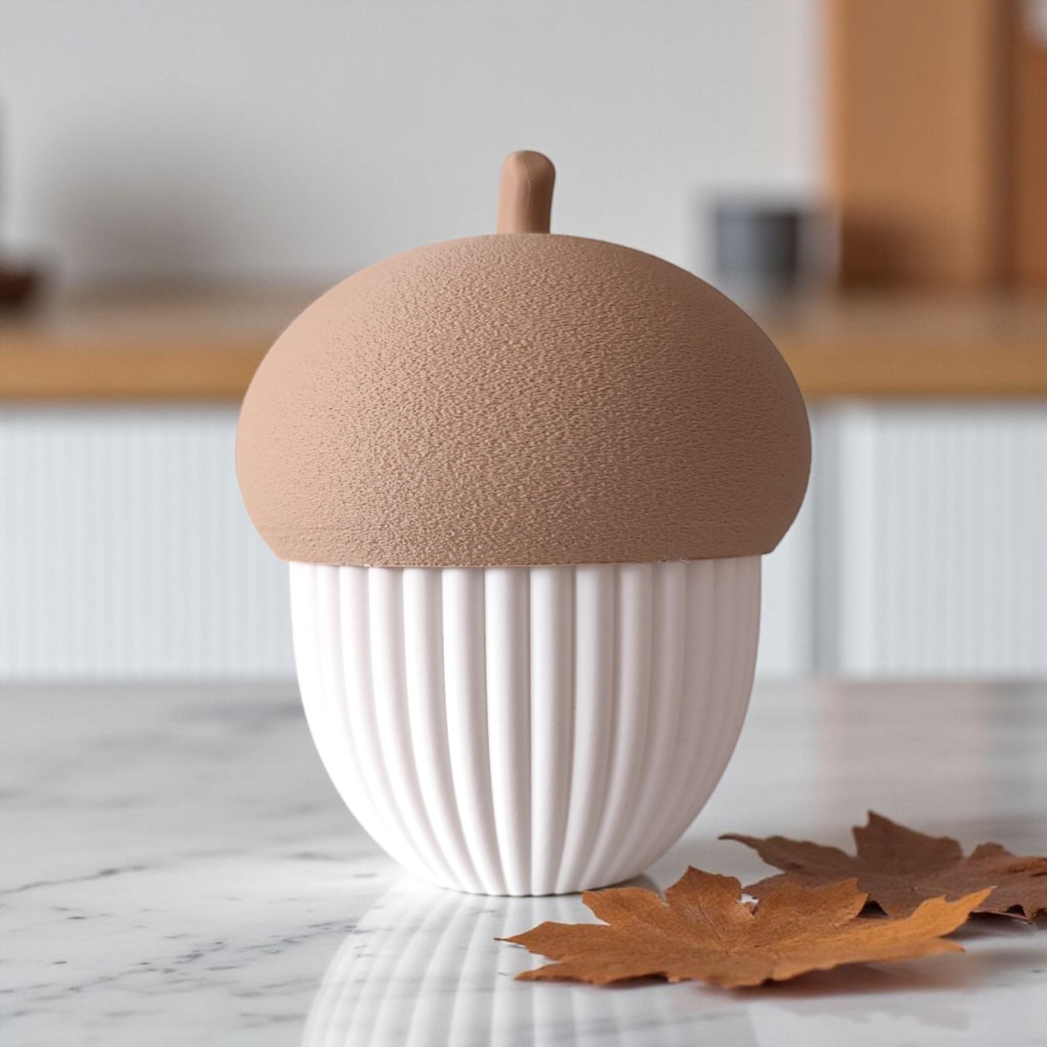 acorn-shaped container on a marble surface with a blurred kitchen background