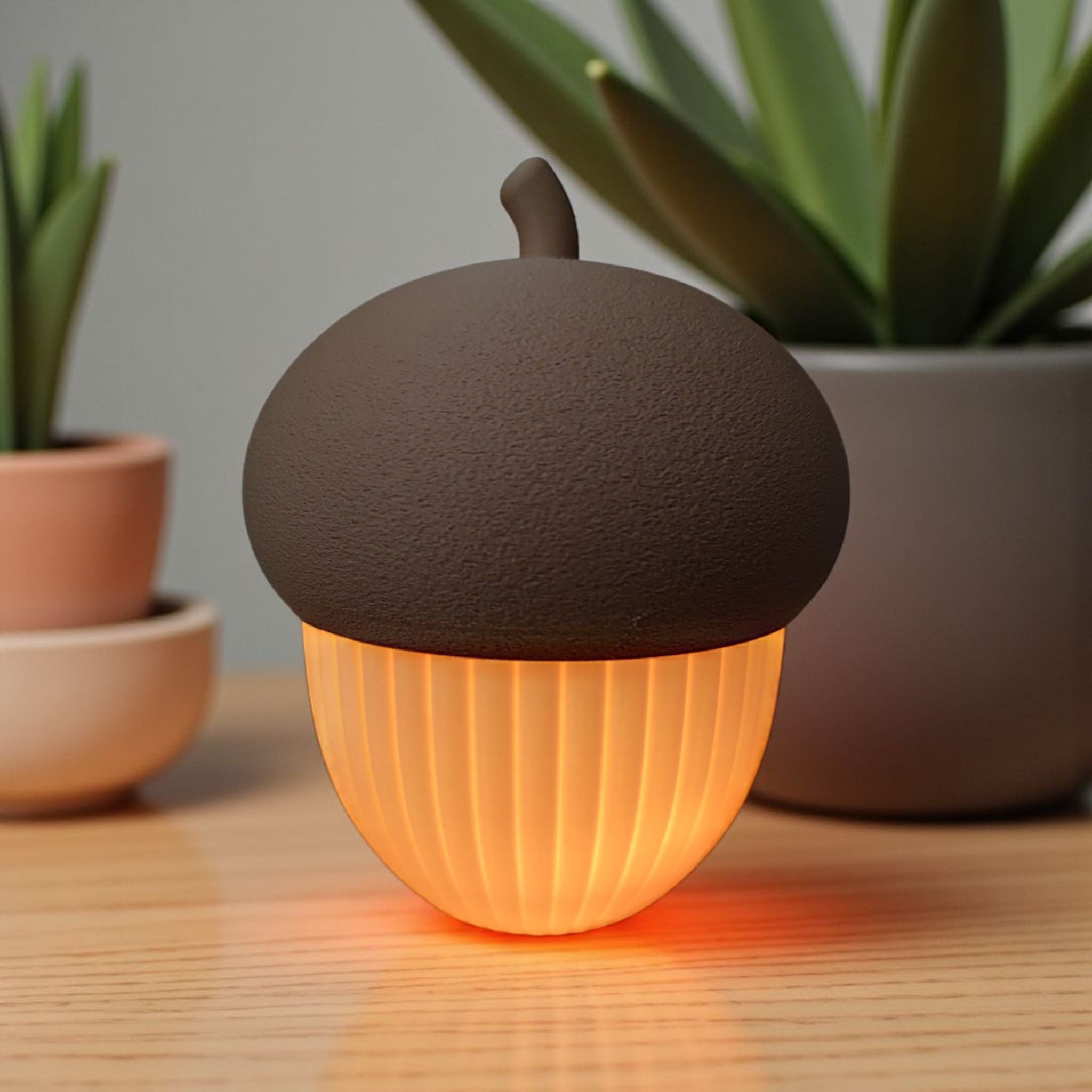 Acorn-shaped lamp emitting a warm glow on a wooden surface with plants in the background.