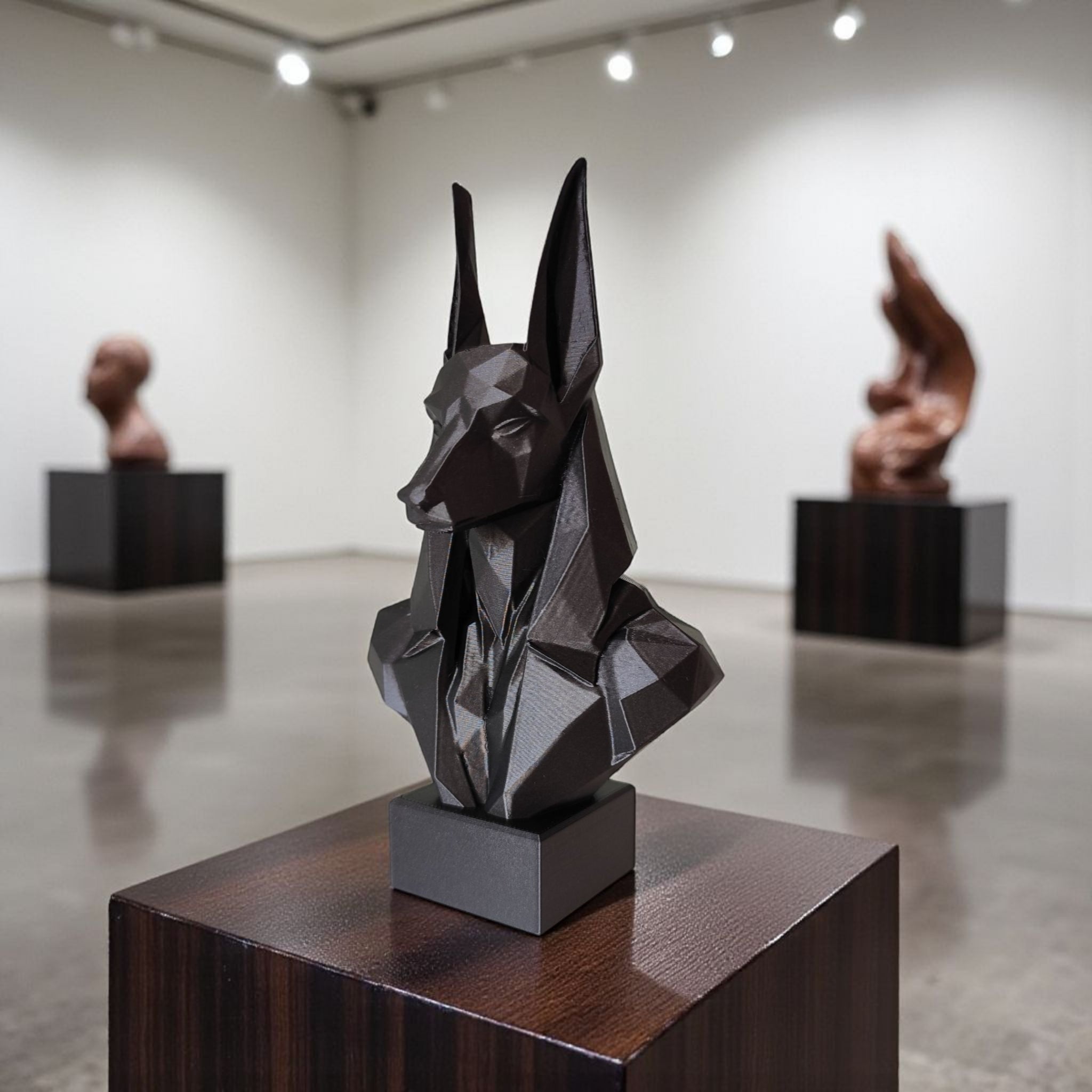 Geometric sculpture of a face on a pedestal in an art gallery setting.