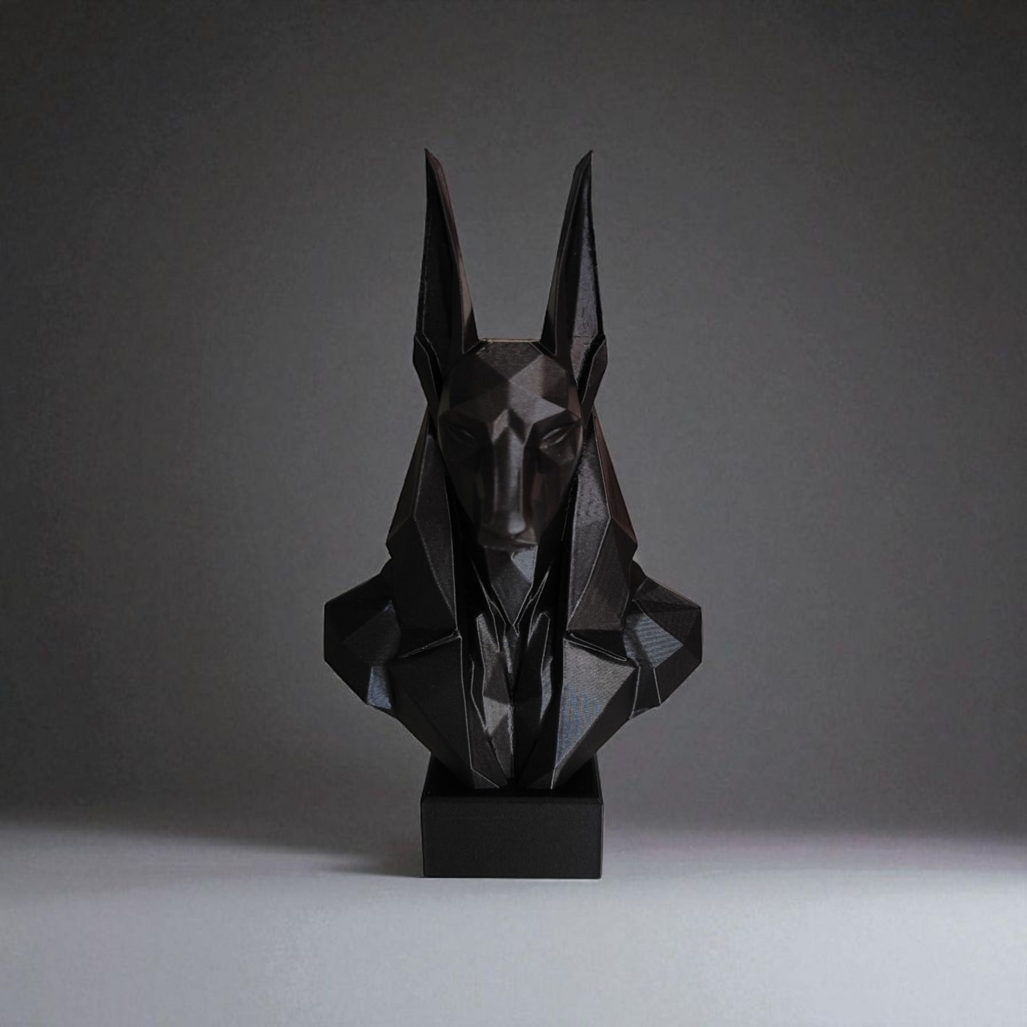 Geometric sculpture of a dog's head on a gray background
