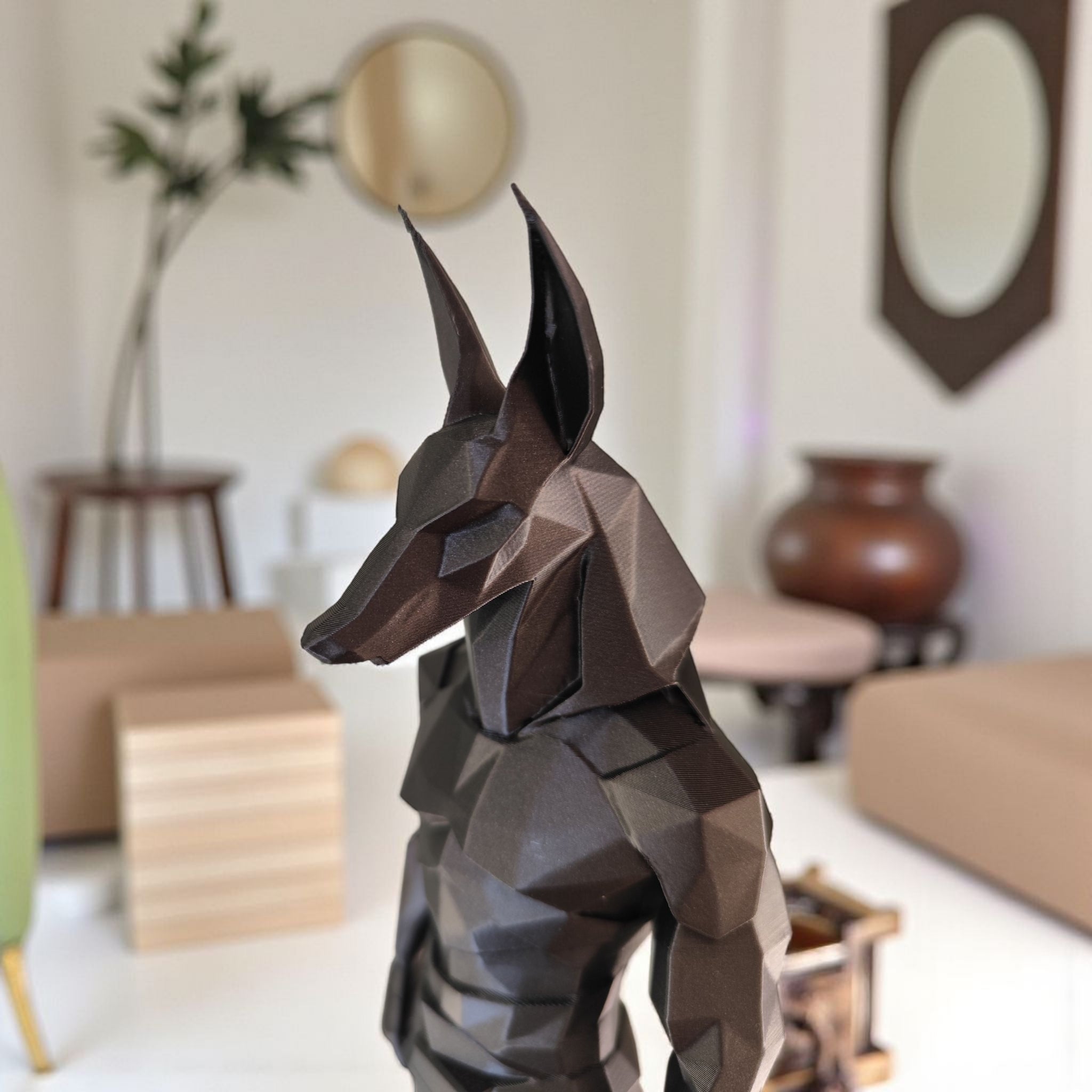 Low poly Egyptian Anubis sculpture on display shelf
