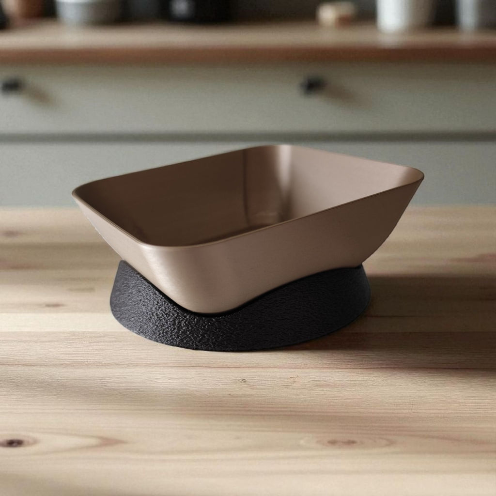 Modern plastic bowl with black base on a wooden surface