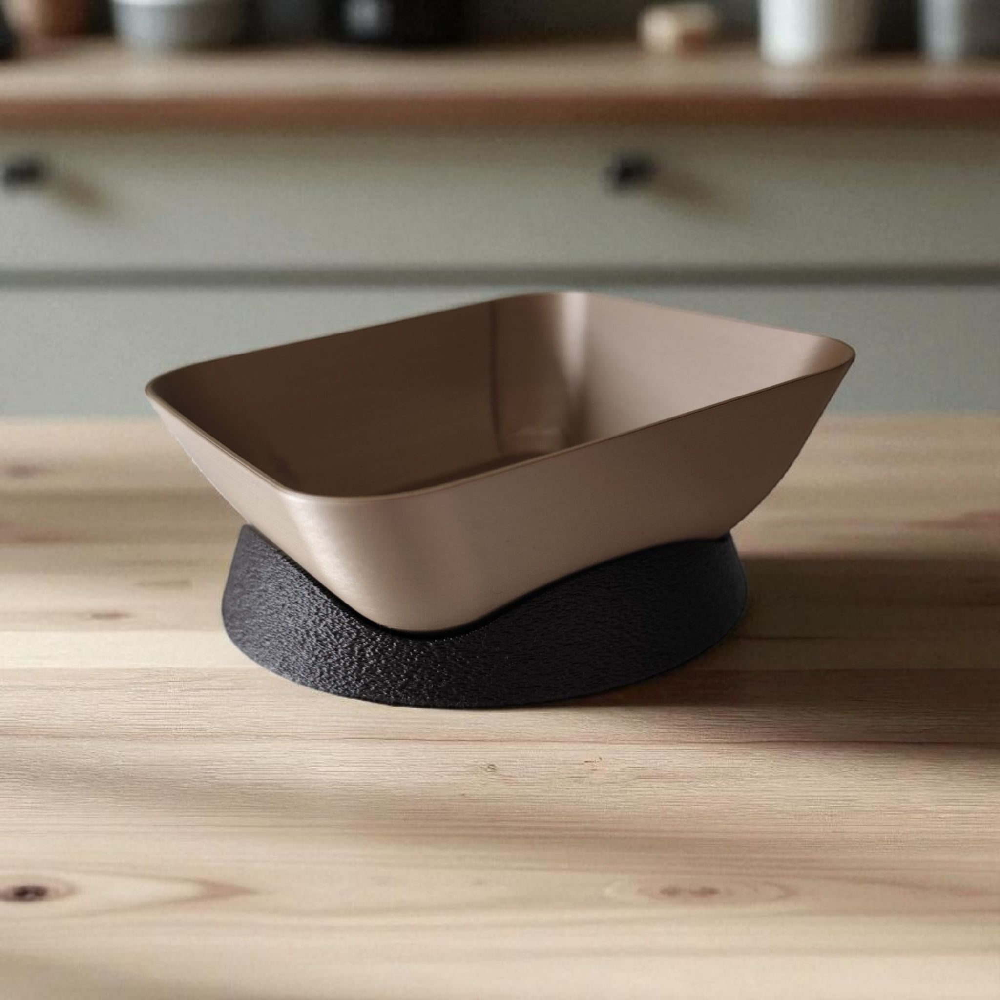 Modern plastic bowl with black base on a wooden surface