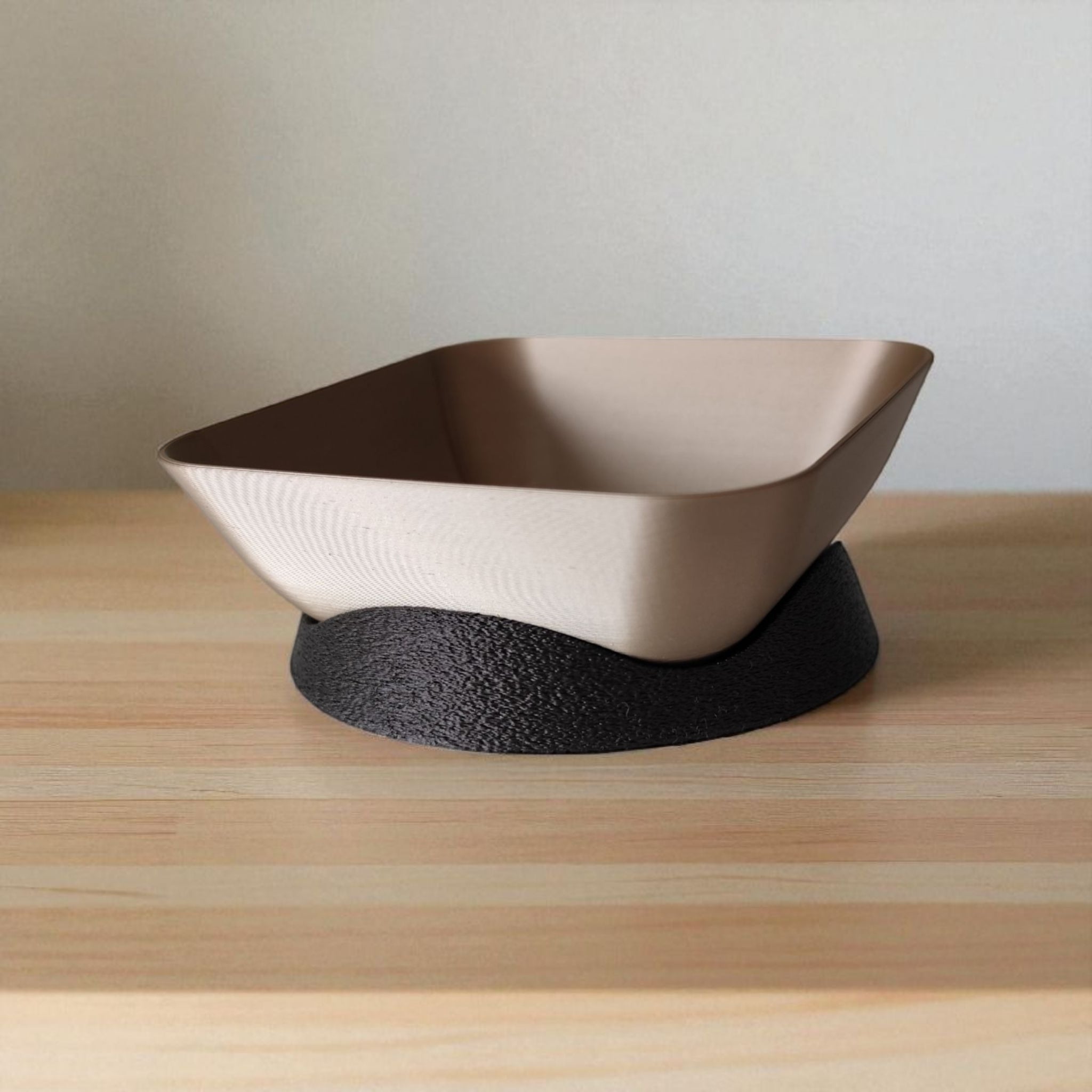 Modern plastic bowl with textured black base on a wooden surface