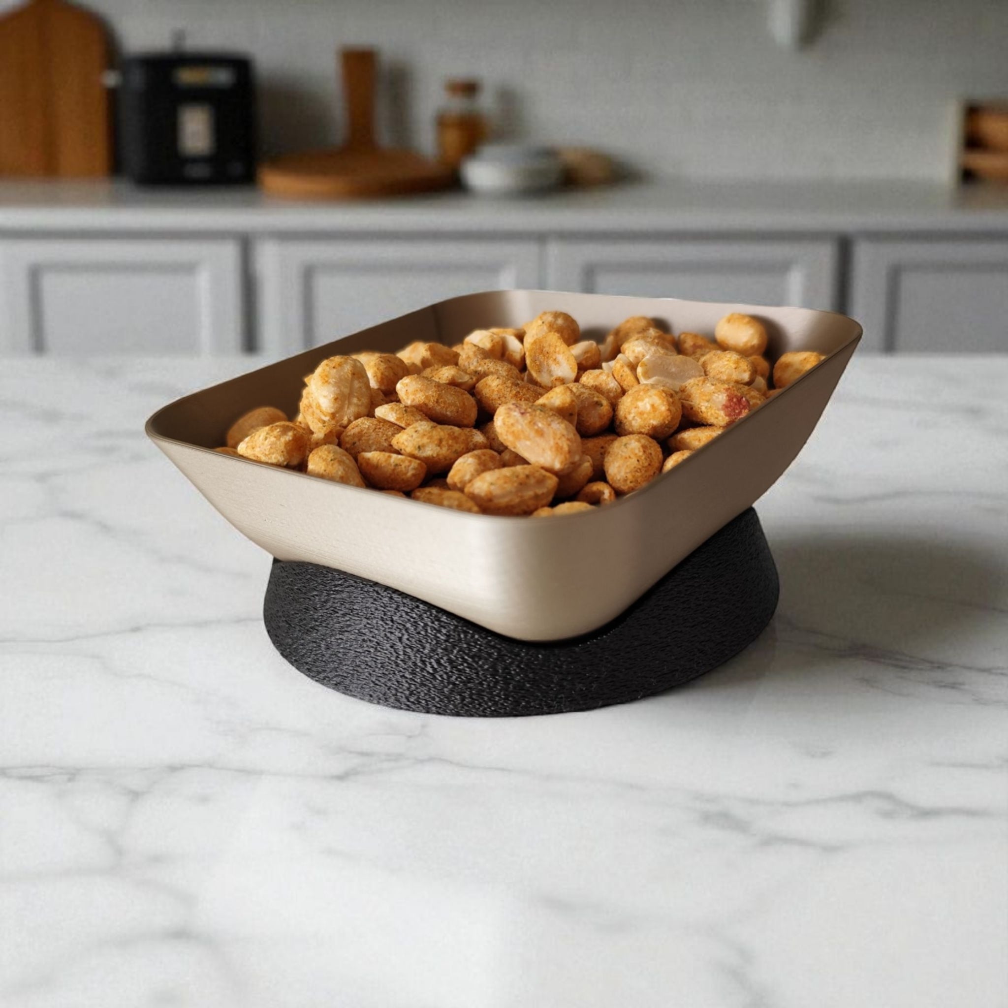 Bowl of snacks on a marble surface with a kitchen background