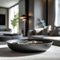 Black bowl with keys on a table in a modern living room