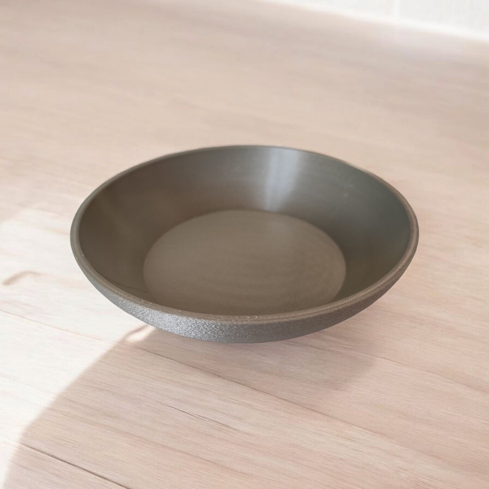 Brown bowl on a light wooden surface