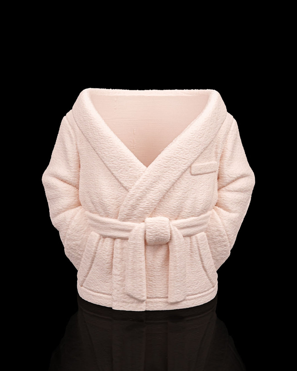 Light pink textured shrug on a black background