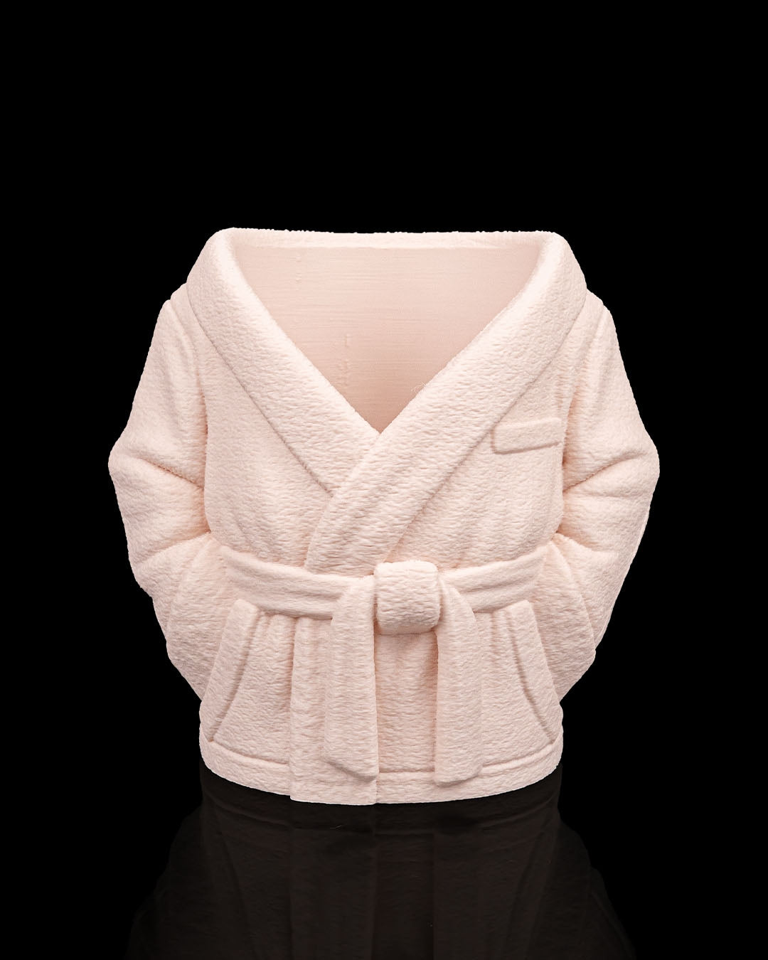 Light pink textured shrug on a black background
