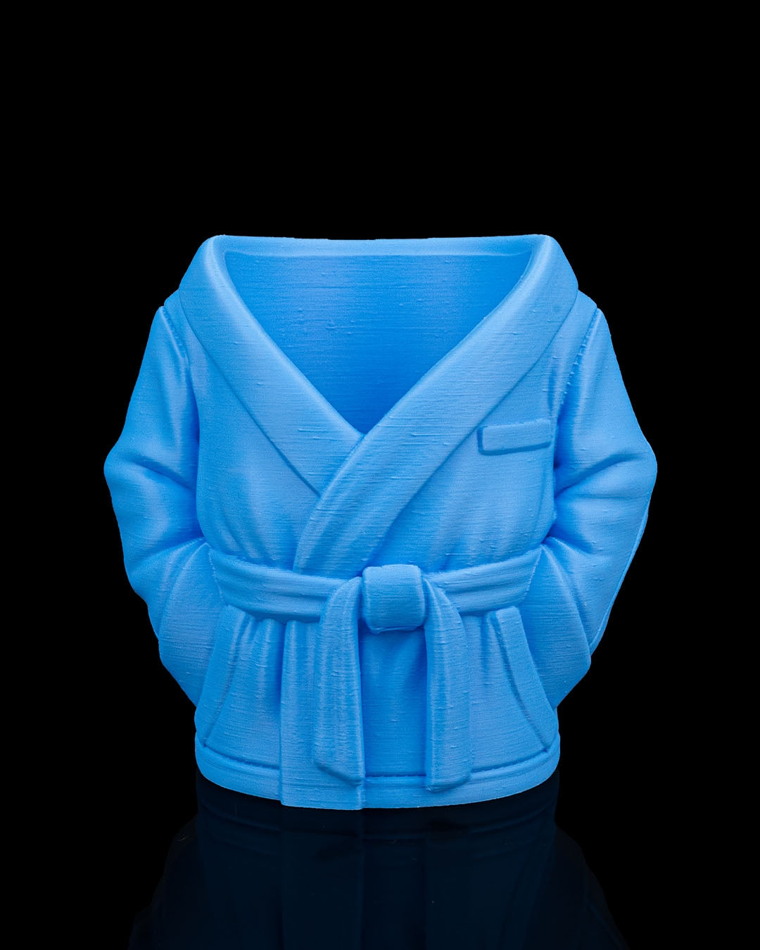 Blue robe-shaped vase on a black background