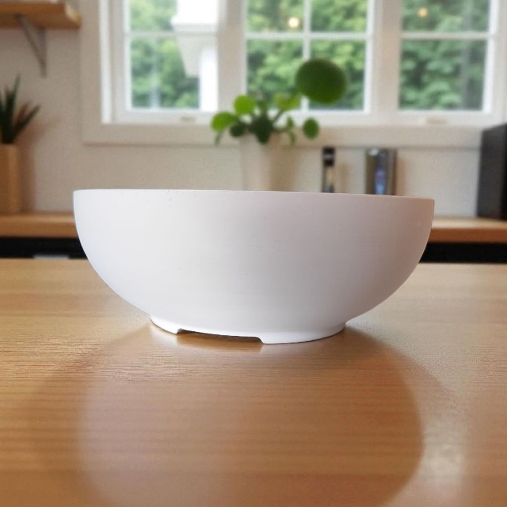 White bowl on a wooden table with a blurred background