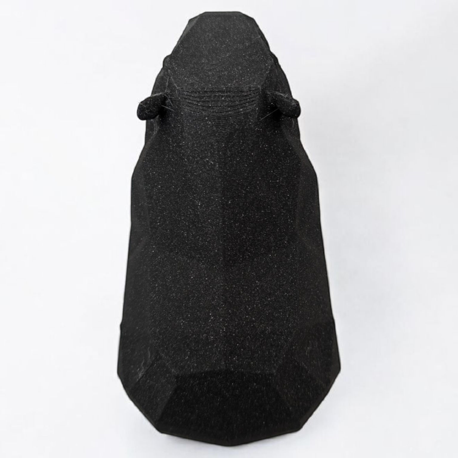 Close-up shot of the capybara statue highlighting the clean, geometric lines.