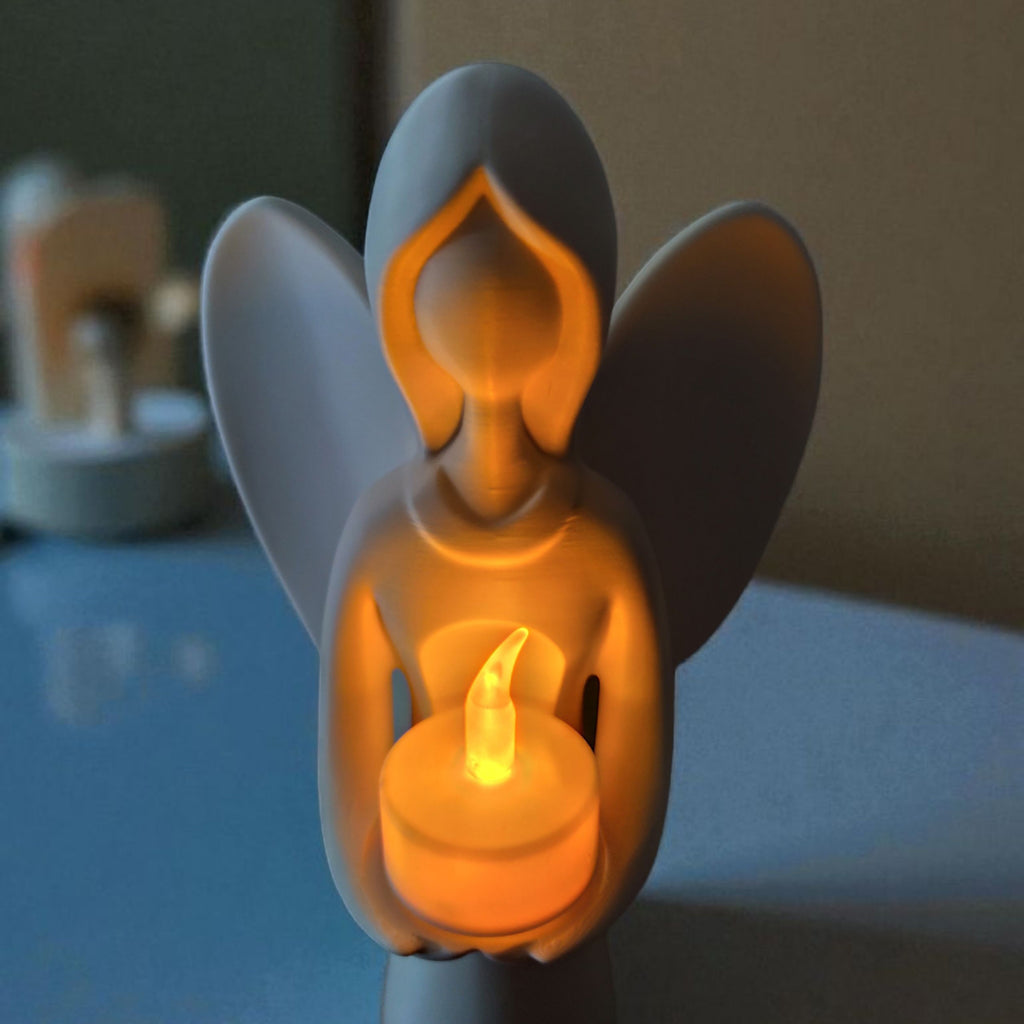 Decorative angel figurine with a candle inside, glowing softly.