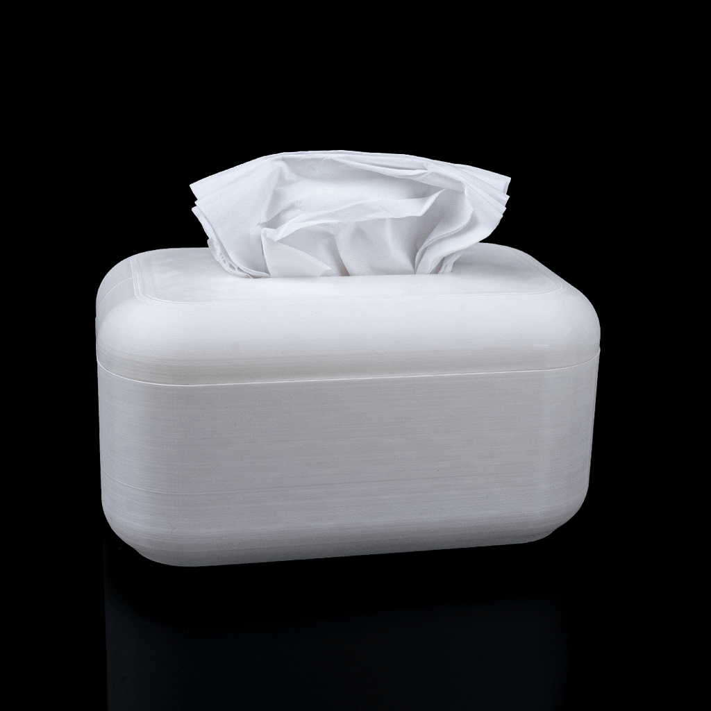 White tissue box with tissues on a black background