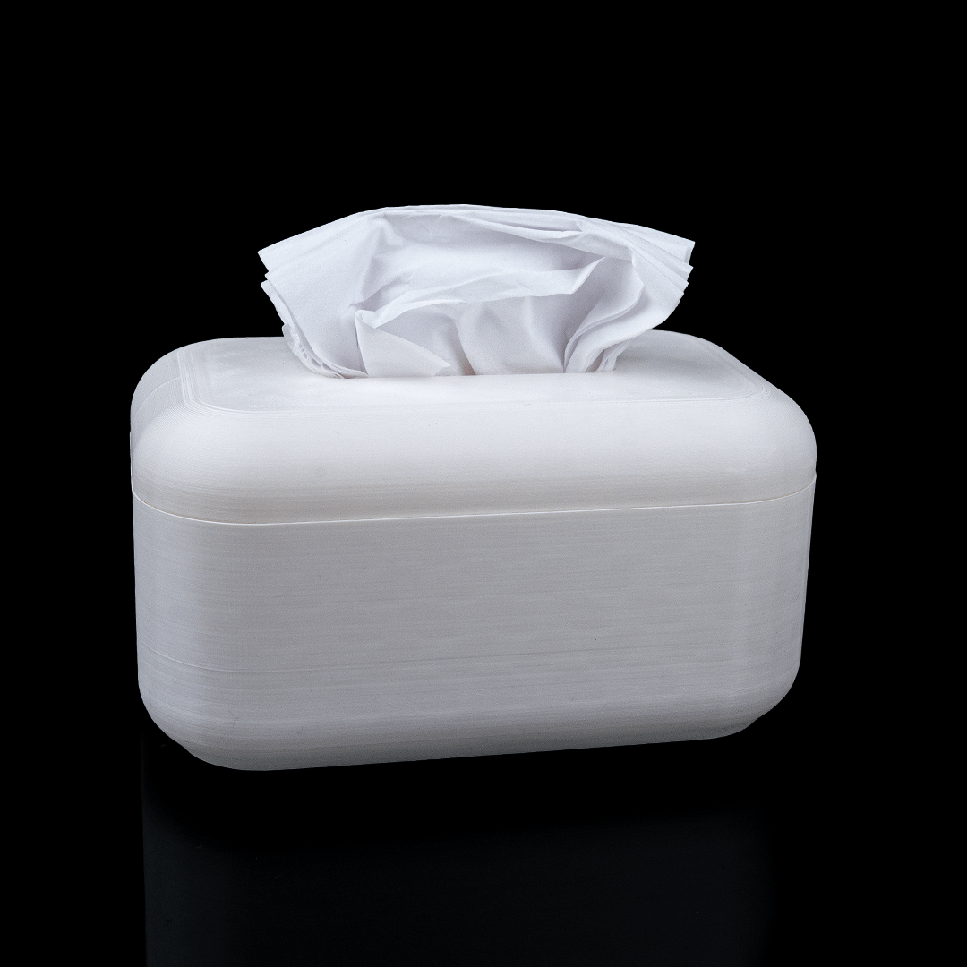 White tissue box with tissues on a black background