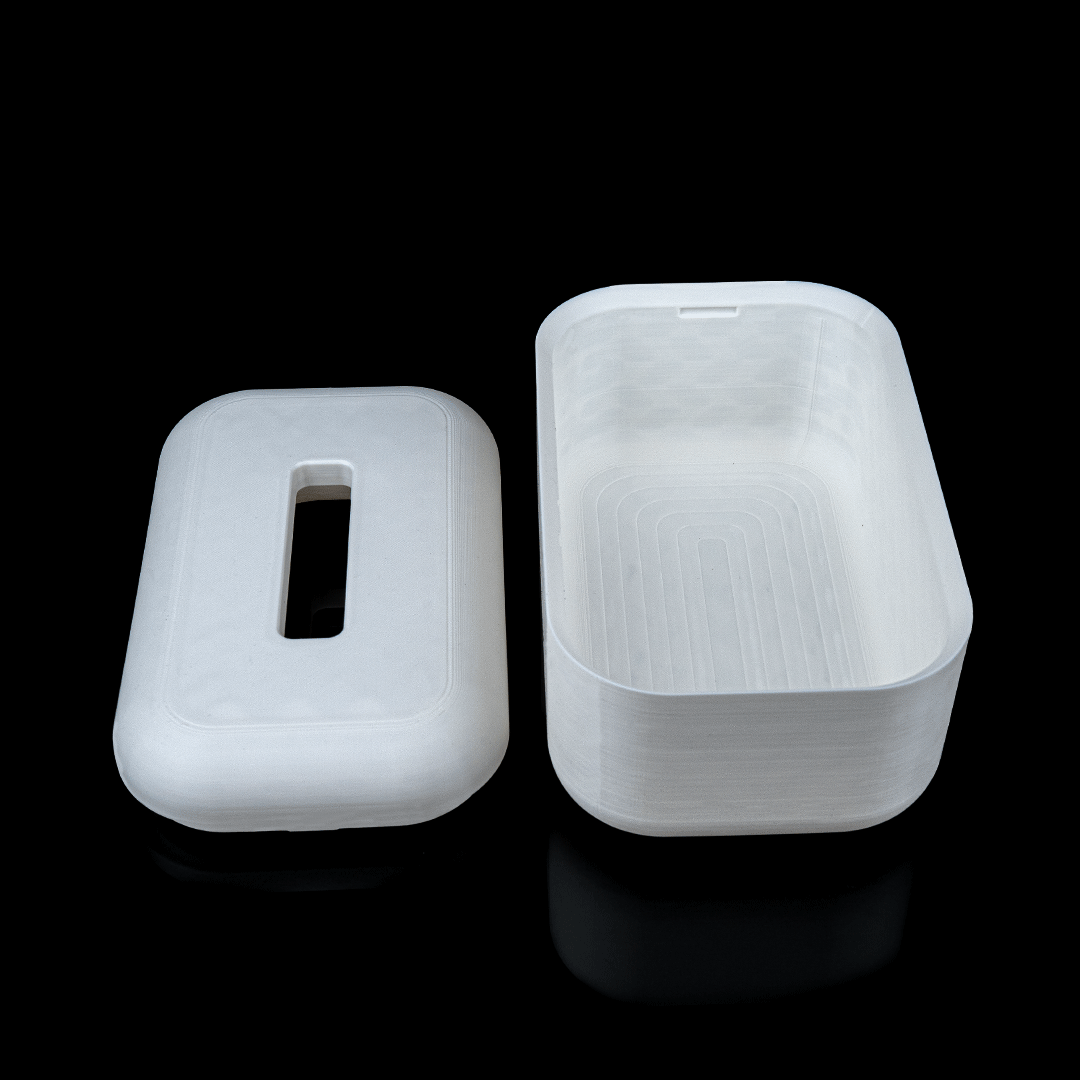 Two white plastic containers on a black background