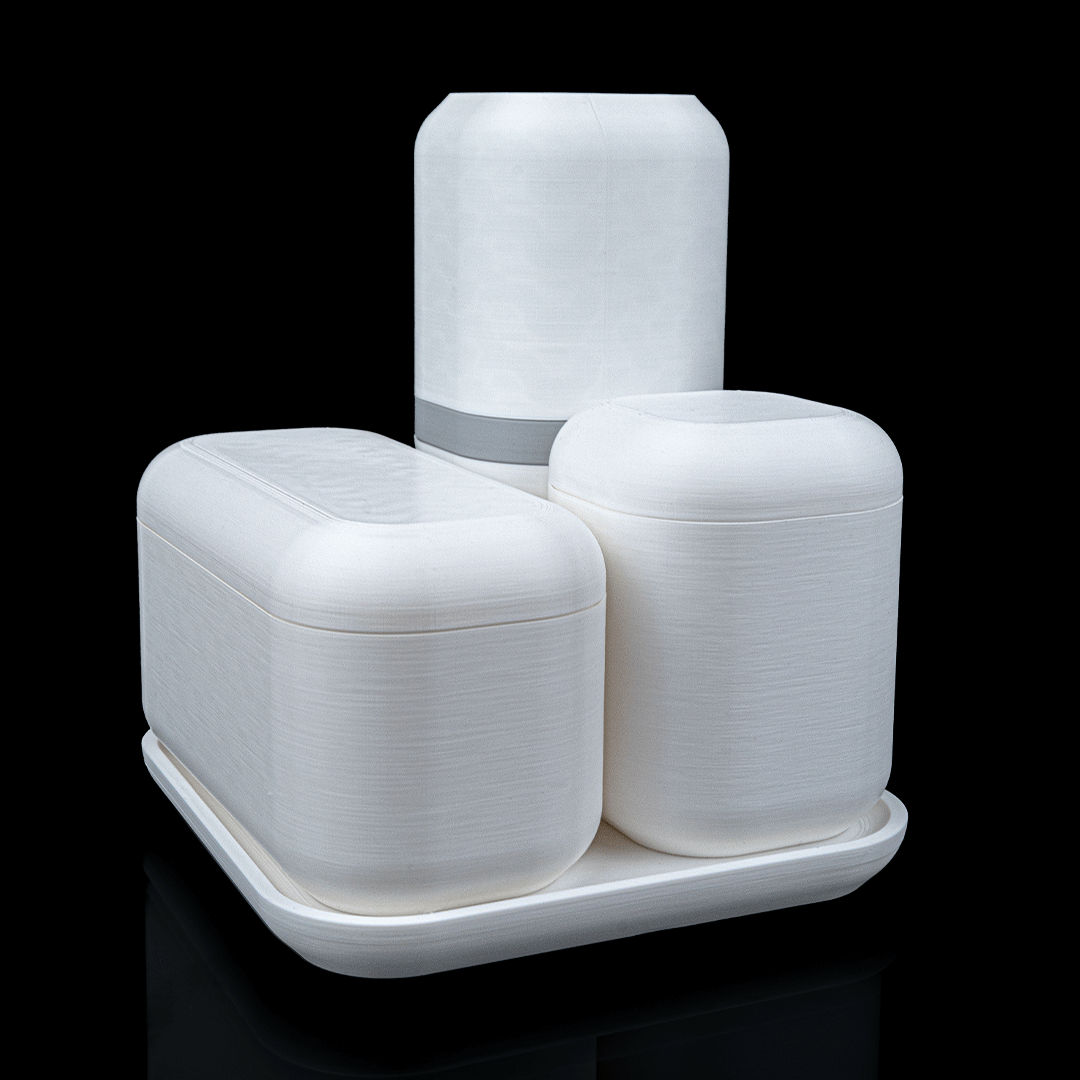 Set of white ceramic containers with lids on a black background